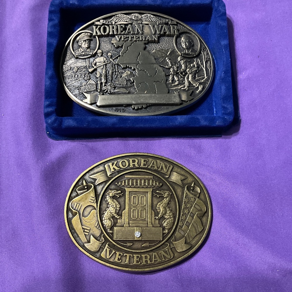 2 belt buckles commemorating the Korean War veterans. M192